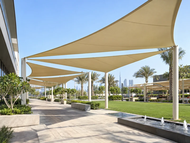 Tensile shade sails across a landscaped courtyard