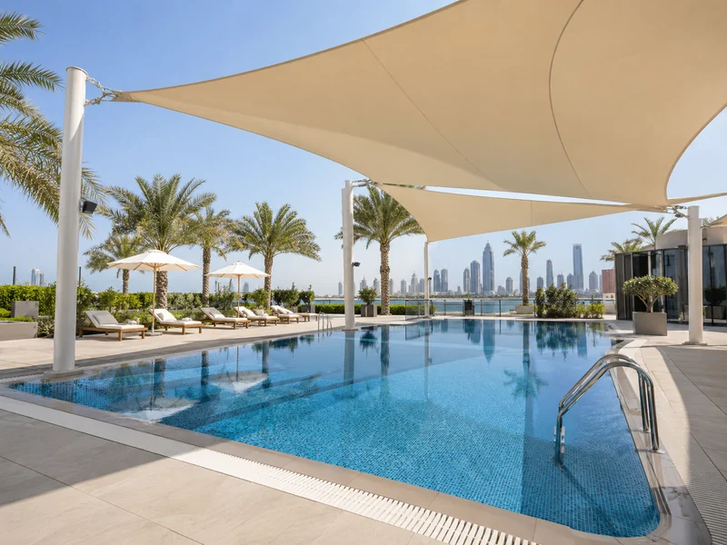 Tensile shade canopy beside a swimming pool