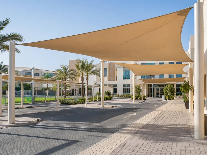Tensile shade canopies across a modern school courtyard